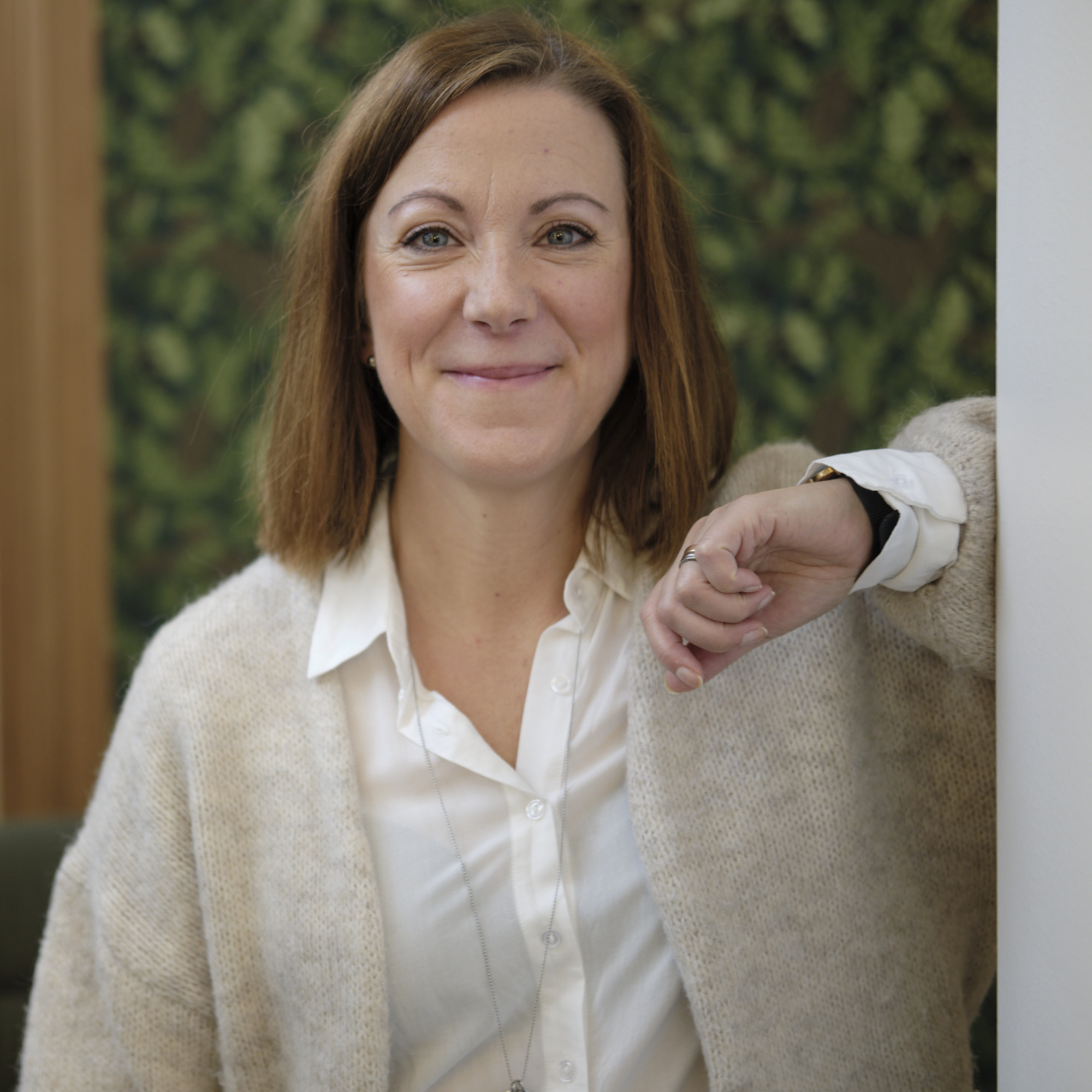 En leende kvinna som tittar in i kameran